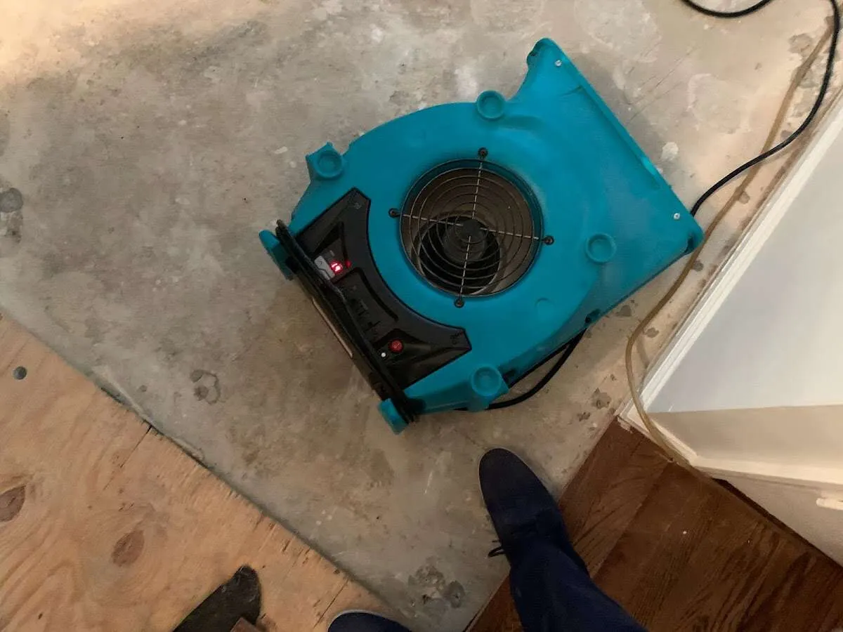 Air mover drying subfloor during Commercial Water Damage Restoration in Lewisboro